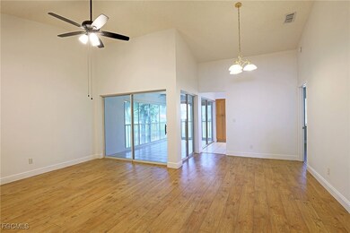 Empty room featuring a high ceiling, a chandelier,