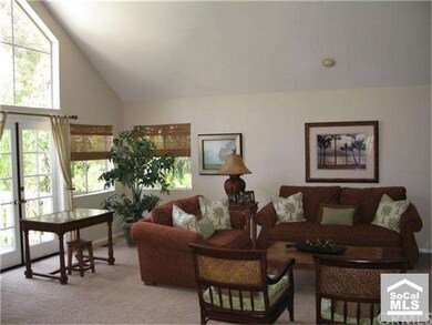 Living room with elegant fireplace leading to a su