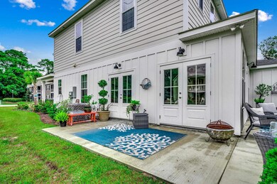 Back of house with a yard, a fire pit, french door