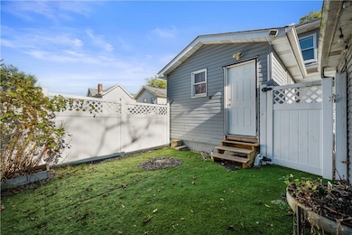 maintenance free turf back yard with privacy fence!