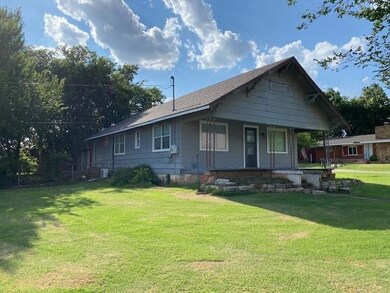 Bungalow-style home with a porch and a front lawn