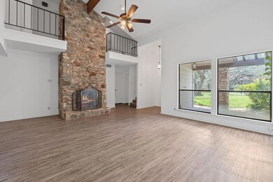 Unfurnished living room featuring high vaulted ce