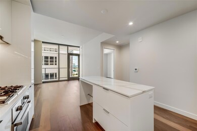 Kitchen with dark wood-type flooring, a center is
