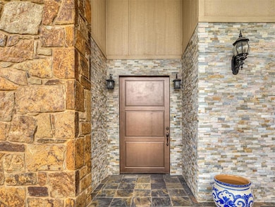 Property entrance featuring stone siding