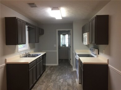 Gorgeous tile in kitchen leads to spacious laundry room