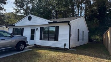 View of front of house with fence and a front yard