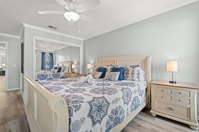 Bedroom featuring a closet, ceiling fan, light har