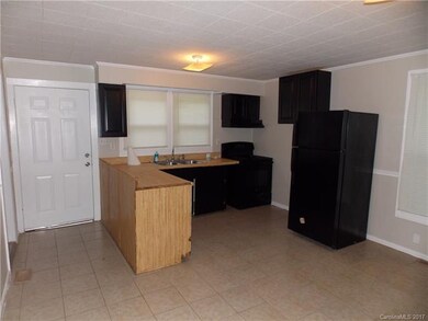Open kitchen with tile flooring