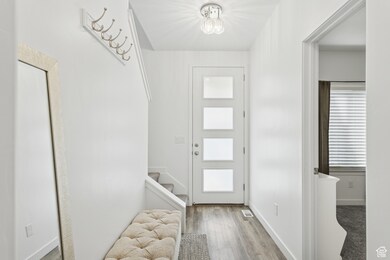 Entrance foyer featuring light wood-type flooring and stairway
