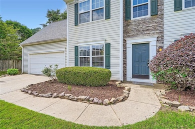View of exterior entry with stone siding, a garage