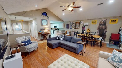Living room with ceiling fan, lofted ceiling, and 