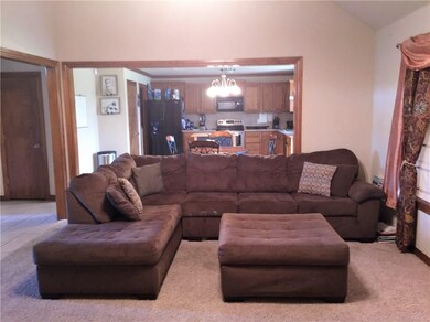 Living Room opens to Dining and Kitchen area.