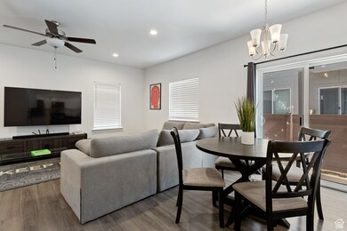 Living room with wood finished floors, recessed lighting, and a chandelier