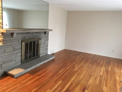 Living room freshly painted with hardwood floors a
