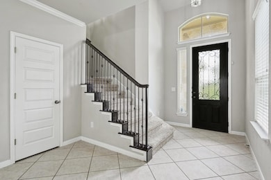 Foyer with a wealth of natural light, light tile 
