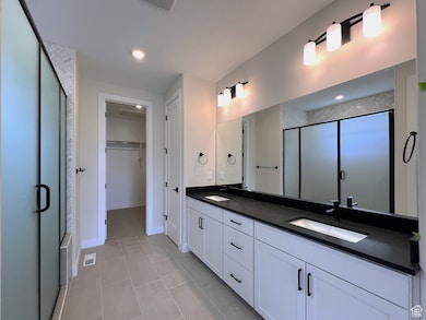 Owner's bathroom with a large walk-in shower, double vanity and a spacious closet,