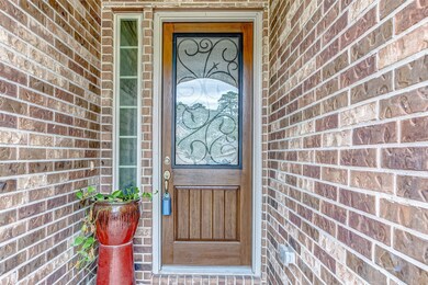 Elegant front door with decorative glass and wroug