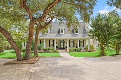 New england style home featuring a front lawn, a 