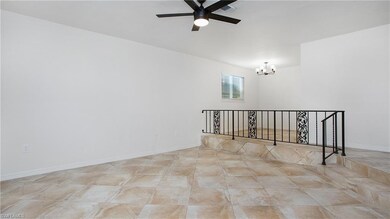 Unfurnished room with a chandelier and ceiling fan
