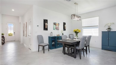 Dining space with baseboards, light tile patterned floors, and recessed lighting