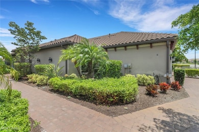 View of side of home featuring stucco siding, lush