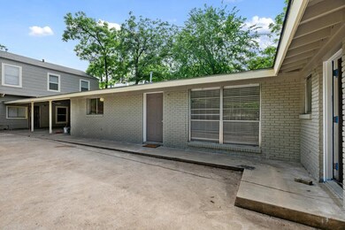Back of house with brick siding and a patio