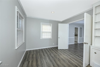 Unfurnished bedroom with dark wood-type flooring, recessed lighting, and crown molding