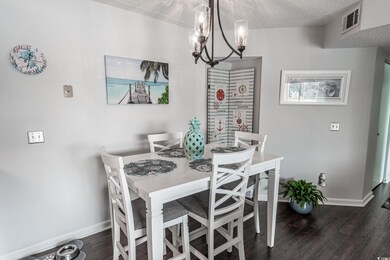 Dining area with a notable chandelier, a textured 
