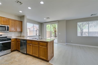Kitchen with stainless steel appliances, a peninsu