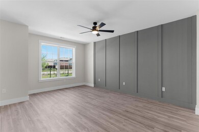 Spare room featuring ceiling fan and light wood-type flooring