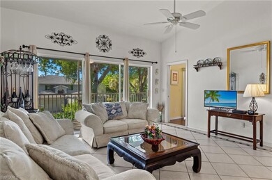 Living room with ceiling fan and light tile patter