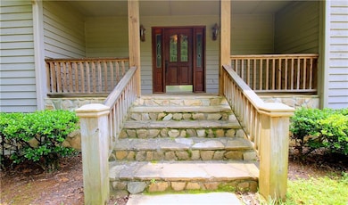View of exterior entry with covered porch