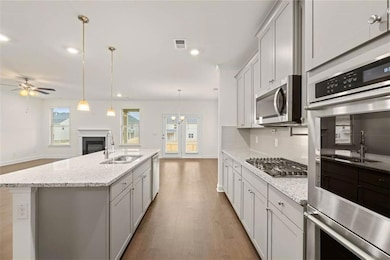 Kitchen with backsplash, stainless steel appliance