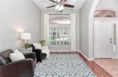 Formal living area with large windows and curved e