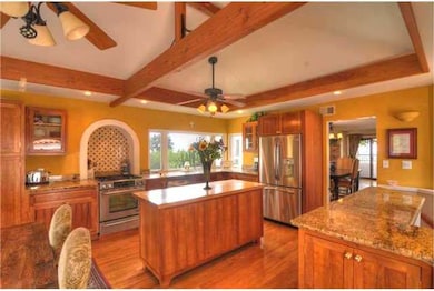 Kitchen with custom tile back splash and view to s