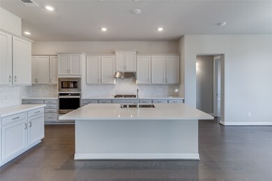 This kitchen is by far any chef’s dream! This spacious kitchen features large windows, high ceilings, white stained wood cabinets, quartz countertops, SS appliances, modern tile backsplash, recessed lighting, extended counter space, large kitchen island with space for breakfast bar, and a walk-in pantry all overlooking your huge family room.
