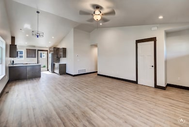 Unfurnished living room with recessed lighting, light wood-style flooring, high vaulted ceiling, and a ceiling fan