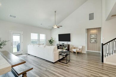Living area featuring high vaulted ceiling, stair