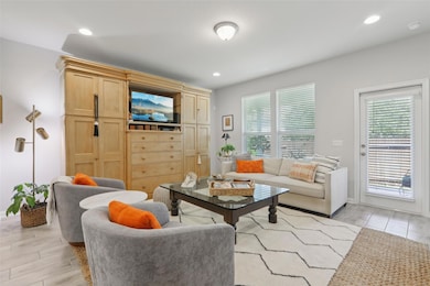 Living room with wood tiled floors, plenty of natural light, and recessed lighting