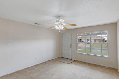 Spare room with carpet floors and ceiling fan