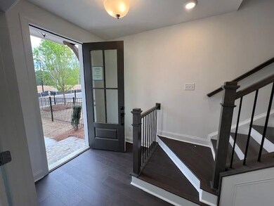 Entryway with dark wood-style flooring, recessed lighting, and stairs