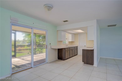 Kitchen featuring a sink, light countertops, white