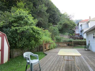 Exterior Back. Rear yard has deck and shed.