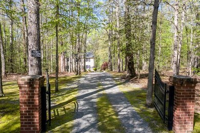 WROUGHT IRON ENTRY GATE LEADS YOU TO AN ELONGATED 