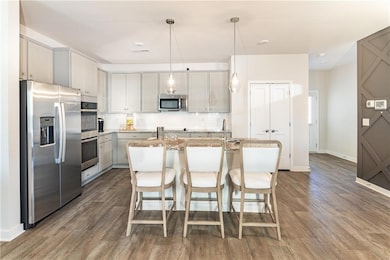 Kitchen with tasteful backsplash, wood finished fl