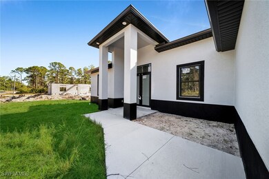 Doorway to property featuring a lawn