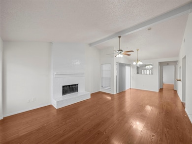 Unfurnished living room featuring ceiling fan with