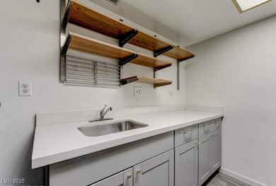 Kitchen featuring open shelves, light countertops,