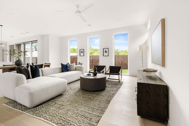 Living room featuring a ceiling fan and light woo