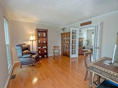 Den with Hard Wood floors, French Doors & Crown Mo